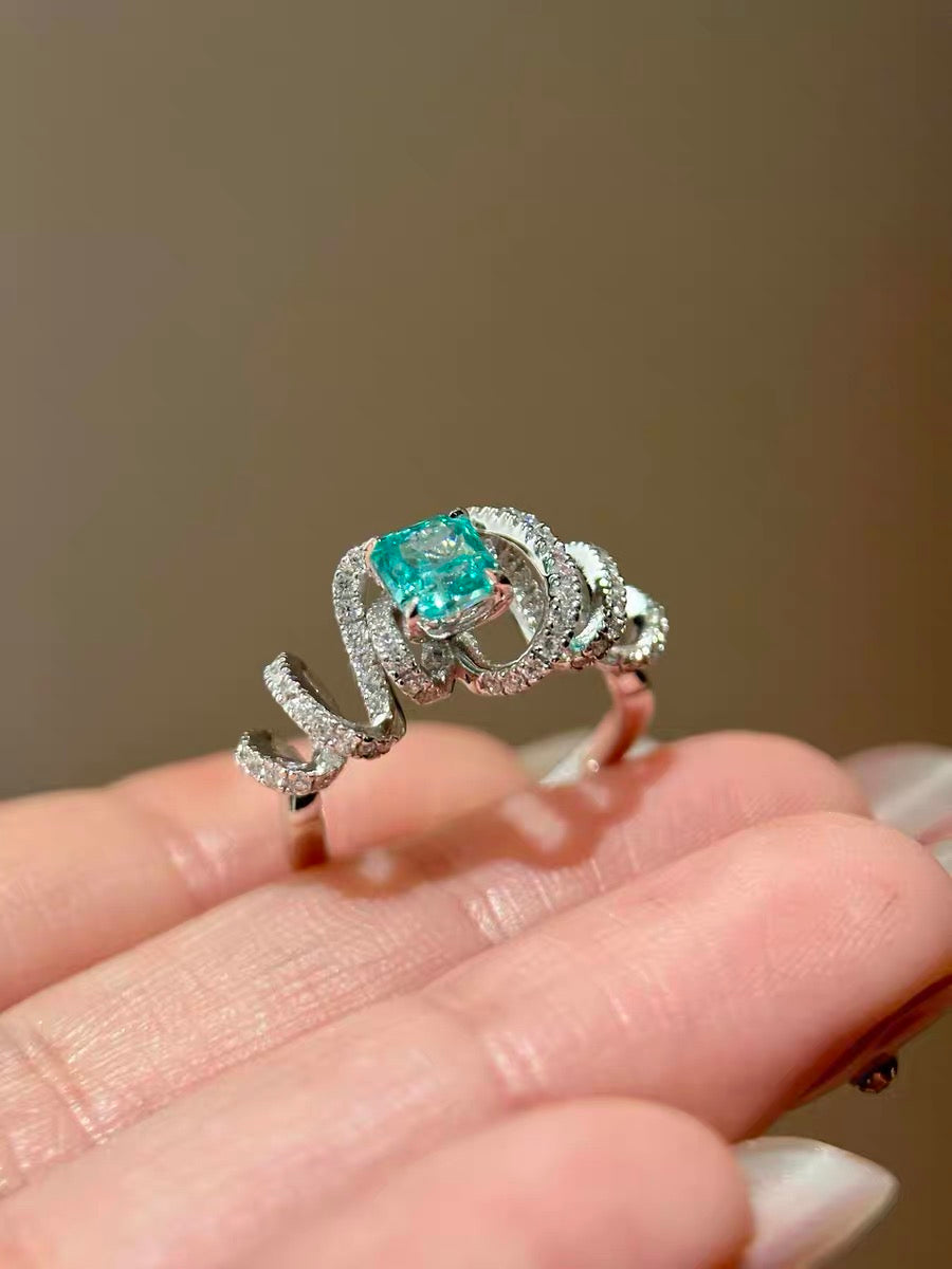 Paraiba Glow adjustable ring with bright color stone and wrap detail
